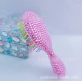 Rosa Mini-Haarbürste mit Strasssteinen und bunten wellenförmigen Borsten für Styling - Rosa Strass 14x6x3,8cm