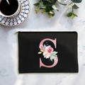 Canvas cosmetic bag with pink letter S and floral print on white marble surface - Letter S