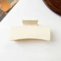 Top view of a beige square hair claw clip on white background with decorative props - 10.5cm / Matte Beige
