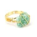 Detail of handcrafted gold wire wrapped ring featuring a natural green raw stone - Adjustable Open / Green Aventurine