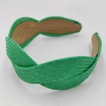 Close-up of bright green straw braided headband with cross-knot detail and brown lining - Green