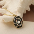 Golden chain necklace featuring a black oval enamel pendant with evil eye design on shell - Gold Black Oval Evil Eye Style