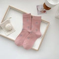 Pink mid-calf cotton socks featuring grey star patterns in a cozy wooden tray setting - Pentagram / Pink