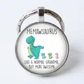 Silver round keychain with Memawsaurus cartoon dinosaurs and family theme design - Dinosaur Family/Memawsaurus