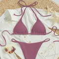 Mauve ribbed halter bikini set with tie-side bottoms laid flat on a beach aesthetic background - Dusty Pink