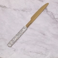 Detalle de un cuchillo de mantequilla dorado con mango brillante de diamantes de imitación - Cuchillo de Mesa / Dorado