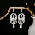 Bohemian silver floral hollow earrings with tassels hanging on a rustic branch - Hollow Ethnic Tassel Style (E6073-31.)
