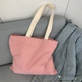 Detail of red and white striped canvas tote bag on a grey sofa with beige shoulder straps - Red Stripe Beige Strap