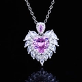 Macro shot of pink heart-shaped pendant with angel wings on a reflective black surface - Pink Zirconia Pendant (No Chain)
