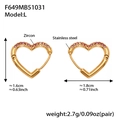 Detail view of heart-shaped gold stainless steel earrings with pink zircon stones - Large Pink Zirconia Earrings