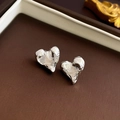 Macro shot of irregular silver heart stud earrings with textured molten metal finish - Silver Wrinkled Heart