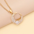 Golden moon necklace with colorful zircon stones on a soft beige fabric background - White