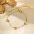 Bracciale in acciaio inossidabile dorato con tre ciondoli a cuore 3D su seta gialla - Bracciale a Cuore / Oro