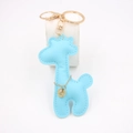 Detailed close-up of light blue PU leather giraffe keychain with gold metal hardware - Light Blue
