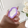 Purple wavy phone grip mirror with Stay Simple inscription shown on a hand - Purple