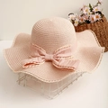 Detail of pink straw hat with satin ribbon bow and lace edges on a summer sun hat - One Size / Light Pink