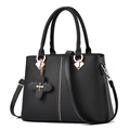 Elegant black PU leather handbag for women featuring gold hardware and floral pendant - Black