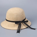 Detailed view of the fine raffia weave and black bow ribbon on this sun hat - M (56-58cm) / Natural