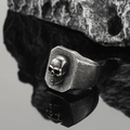 Macro side view of vintage skull signet ring in aged steel with sharp carving details - US 9 / Antique Silver
