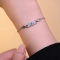 Silver bracelet with zircon inlay featuring four-leaf clover motif on a female wrist - Silver Bracelet (S1119)