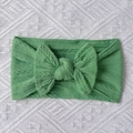 Close-up of grass green cable knit baby headband with a soft large nylon bow detail - Green