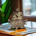 Antique bronze Nine-Dragon incense burner with hollow lid on a wooden desk - Coiled Dragon Censer