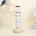Colorful velvet scrunchies and hair bands set on a vertical wood display stand - Beige Velvet with Metal Cap
