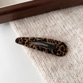 Macro view of leopard print fabric hair clip on soft beige knit background - Coffee Leopard - Water Drop