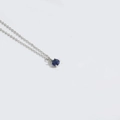 Elegant silver chain necklace with a small round blue sapphire pendant and secure setting - Blue (Silver)