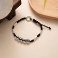 Detailed shot of black woven bracelet featuring five ancient copper coins and silver beads - L393-4 Five Ancient Coins (Black Rope)