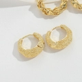 Classic C-shaped hoop earrings with a matte golden sand finish on textured background - Hollow Style