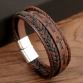 Macro shot of vintage multi-layer braided leather bracelet with cross and magnetic clasp - 21cm / Coffee