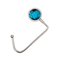 Close-up of a silver portable table hook with a faceted blue diamond decoration - Navy Blue