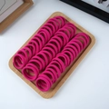 Top view of high-elastic rose red seamless hair ties neatly arranged on a wooden tray - 50 Pieces / Rose Red
