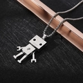 Macro shot of a silver robot pendant with hollow body on a durable box chain - XL01 / Robot / Silver