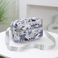 Crossbody bag with blue floral pattern and multiple compartments on white table - Fog Blue Leaves