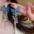 Detail of blue tulle butterfly earrings with crystal tassels and pearls worn by a model - Tulle Butterfly Tassel Style (5#) / Blue/Gold