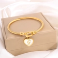 Twisted gold titanium bracelet featuring a heart charm with white letter G on silk - Letter G