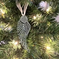 Antique silver angel wing heart ornament hanging on Christmas tree with warm lights - Single Wing with Round Charm