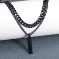 Detail of layered black Cuban chain necklace with rectangular pendant on a white pedestal - Rectangle Pendant Style / Black