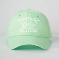 Detailed front view of mint green Vintage 1973 baseball cap with white retro lettering - One Size / Light Green
