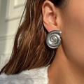 Polished silver seashell spiral stud earrings in a modern stainless steel design - Silver
