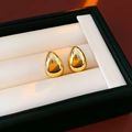 Macro shot of minimalist gold teardrop earrings placed on a premium black jewelry gift box - 925 Silver Needle Style / Gold (Real Gold Plated)