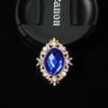 Detailed view of vintage oval blue gemstone alloy brooch with sparkling rhinestones - Sapphire Blue