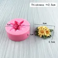 Pink silicone daisy mold with yellow flower craft on blue wood background - 3749 Cluster Daisy / Pink