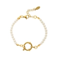 Detailed close-up of a pearl bracelet with a golden stainless steel lobster clasp and tag - Pearl Bracelet Style