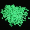 Macro detail of round 7x4mm luminous acrylic beads with letter Z glowing in green - Letter Z / Luminous Green