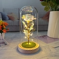 Detail view of colorful LED foil rose in a glass dome with a warm wooden base - Wood Base Warm White Light + Grass