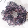 Macro detail of oversized organza hair scrunchie with dark blue and pink floral print - Black Floral