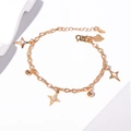 Detail of gold butterfly bracelet with star pendants and lobster clasp on white background - Star and Ball Gold